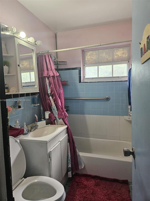 full bath with shower / tub combo with curtain, toilet, tile walls, decorative backsplash, and vanity