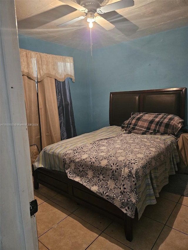 bedroom with tile patterned floors and a ceiling fan