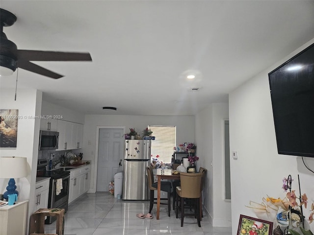kitchen featuring white cabinets, a ceiling fan, visible vents, and stainless steel appliances