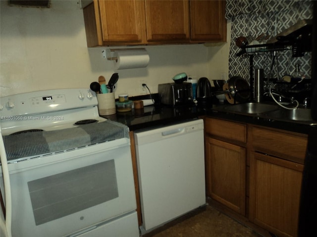 11855 NE 19th Dr Unit 5, North Miami, FL 33181 - kitchen with white appliances, brown cabinetry, and dark countertops