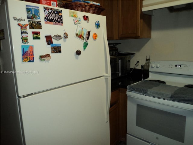 kitchen featuring extractor fan and white appliances