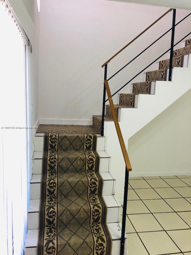 staircase featuring tile patterned floors