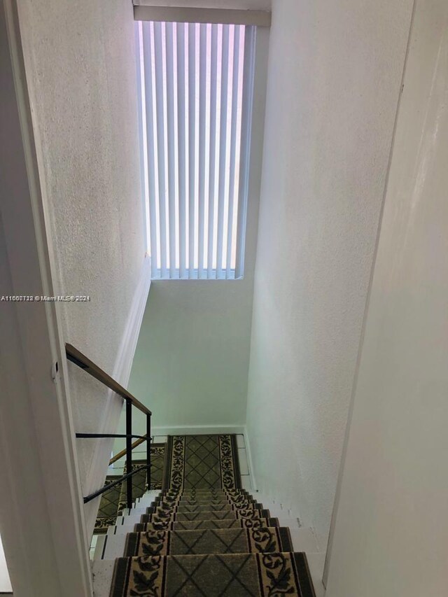 interior space featuring a closet, light tile patterned floors, and a textured ceiling