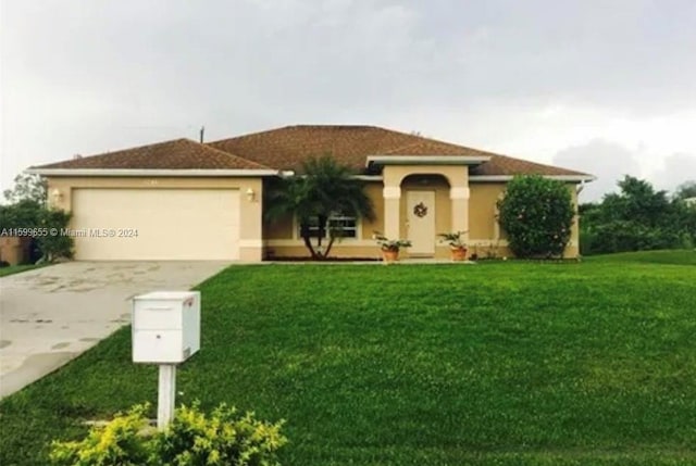 view of front of property with a garage and a front yard