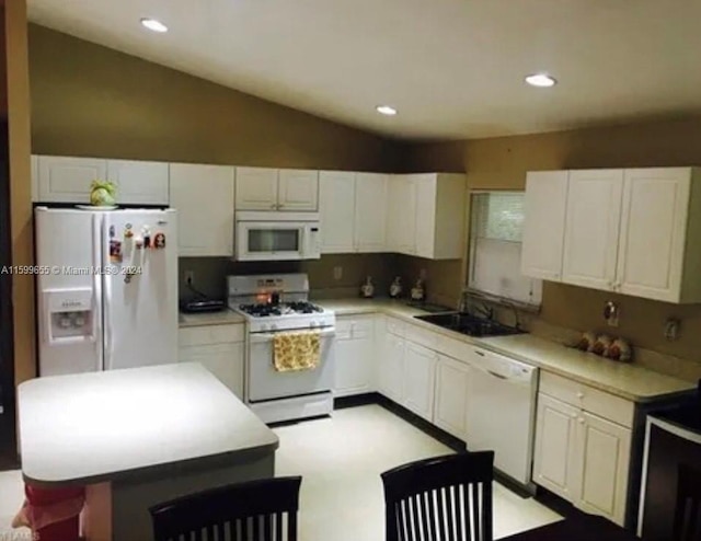 kitchen with lofted ceiling, a kitchen island, white appliances, sink, and tasteful backsplash