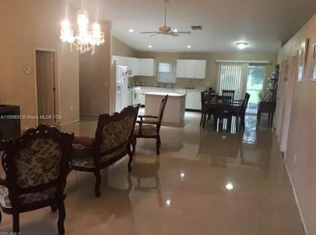 dining space with light tile flooring and ceiling fan with notable chandelier