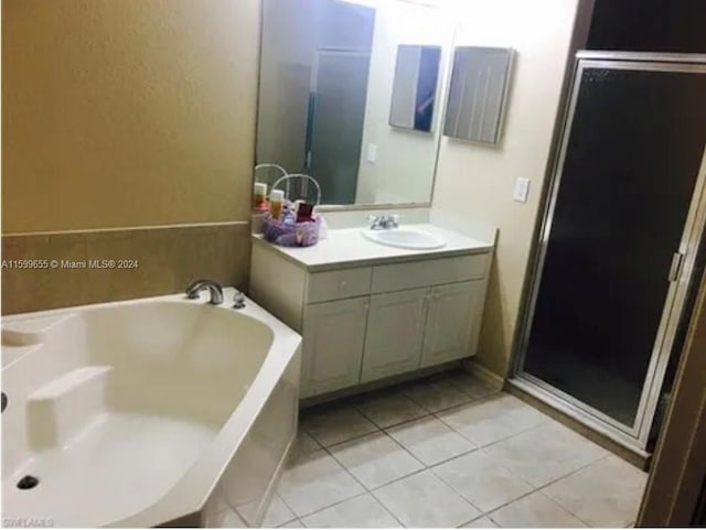 bathroom with vanity with extensive cabinet space, separate shower and tub, and tile flooring