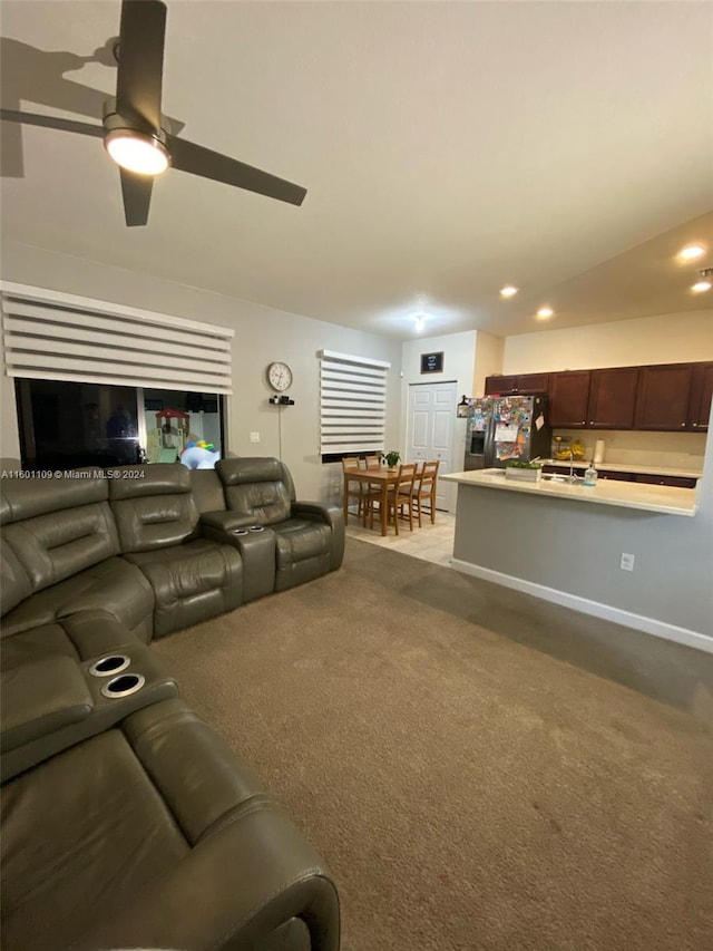 carpeted living room featuring ceiling fan