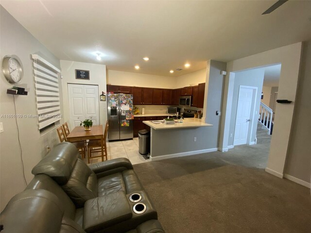 kitchen with light carpet, kitchen peninsula, dark brown cabinetry, and stainless steel appliances