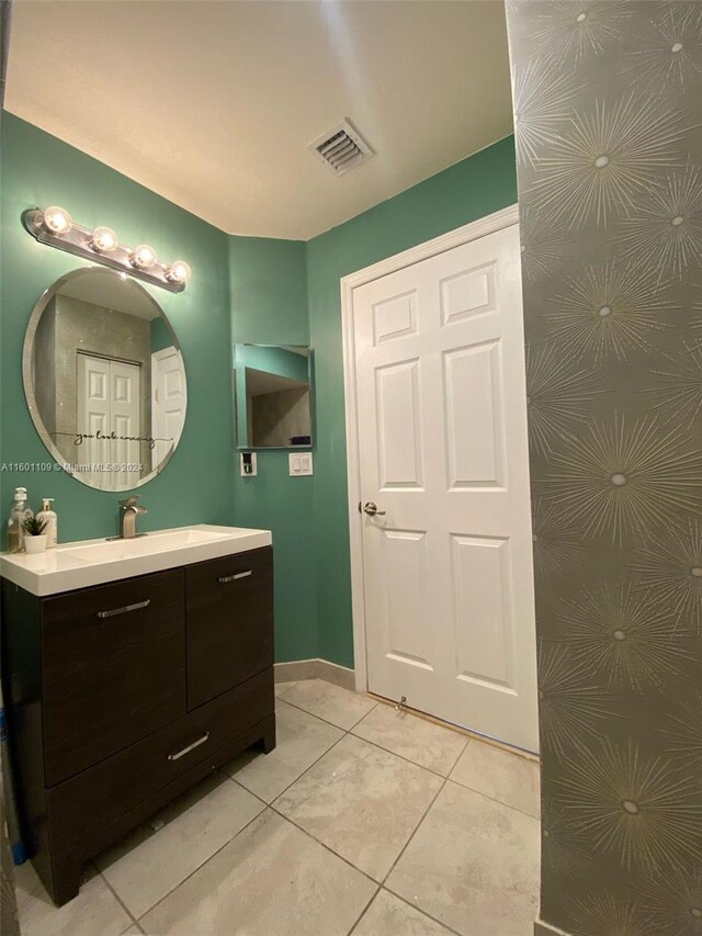 bathroom with vanity and tile patterned flooring