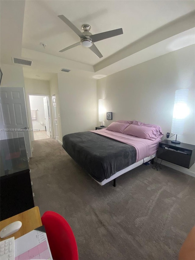 bedroom featuring ensuite bathroom, carpet flooring, and ceiling fan