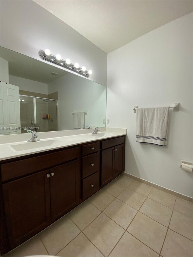 bathroom featuring double vanity and tile patterned flooring