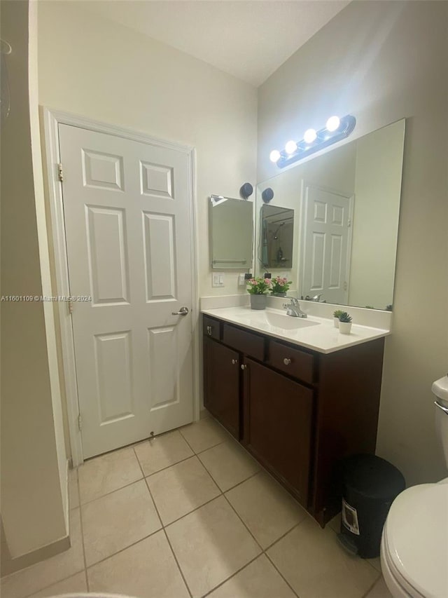 bathroom with vanity, toilet, and tile patterned flooring