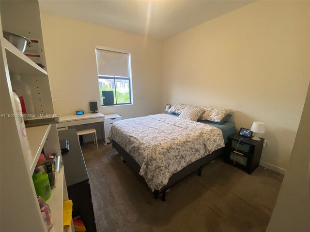 bedroom featuring dark carpet