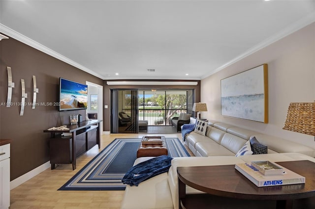 living room featuring light hardwood / wood-style flooring and ornamental molding