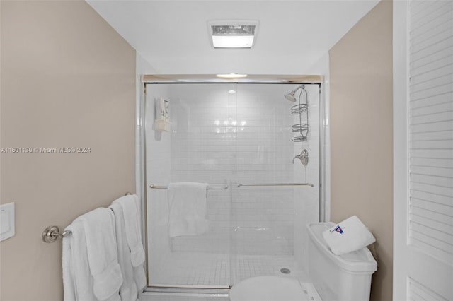 bathroom featuring toilet and walk in shower