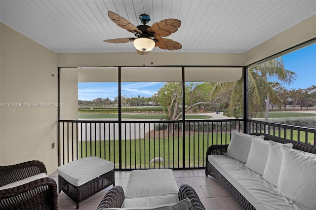 sunroom / solarium with ceiling fan and wood ceiling