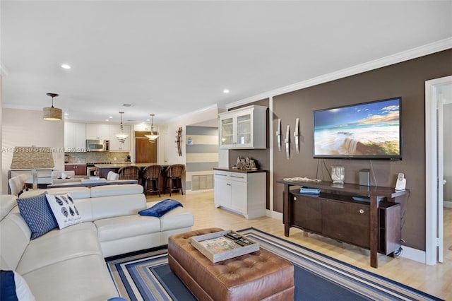 living room with light hardwood / wood-style floors and crown molding