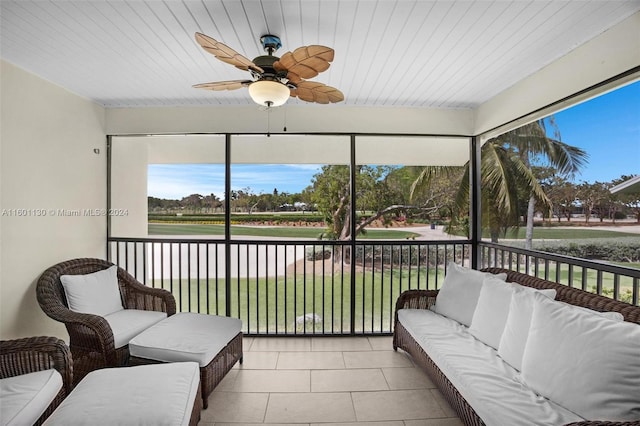 sunroom featuring ceiling fan, wood ceiling, and a wealth of natural light