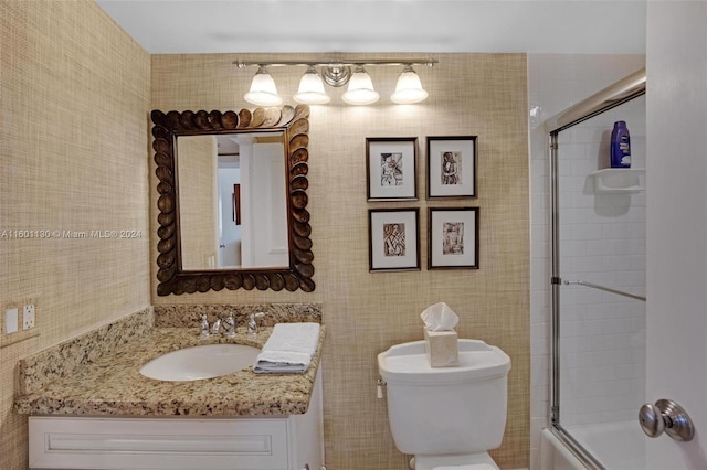 full bathroom with vanity, enclosed tub / shower combo, and toilet