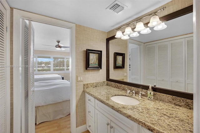 bathroom featuring ceiling fan, wood-type flooring, and vanity