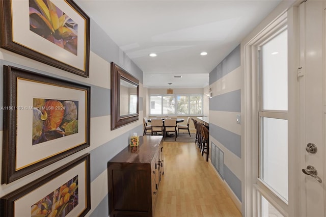 hallway with light hardwood / wood-style flooring