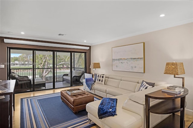 living room with hardwood / wood-style flooring and ornamental molding