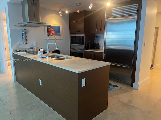 kitchen featuring wall chimney exhaust hood, dark brown cabinetry, sink, black appliances, and light tile patterned floors