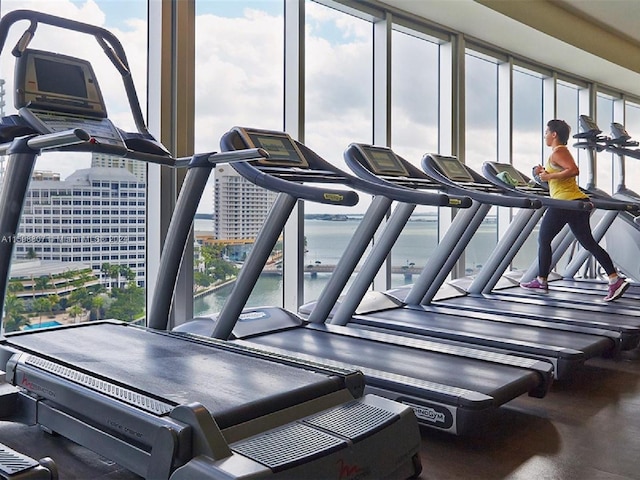 workout area featuring a water view