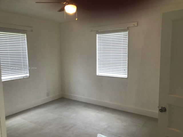 empty room with plenty of natural light and ceiling fan