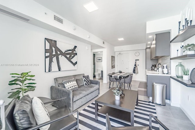 living room featuring light tile patterned flooring and sink