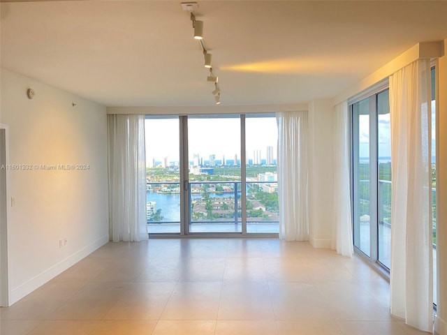 unfurnished room featuring track lighting