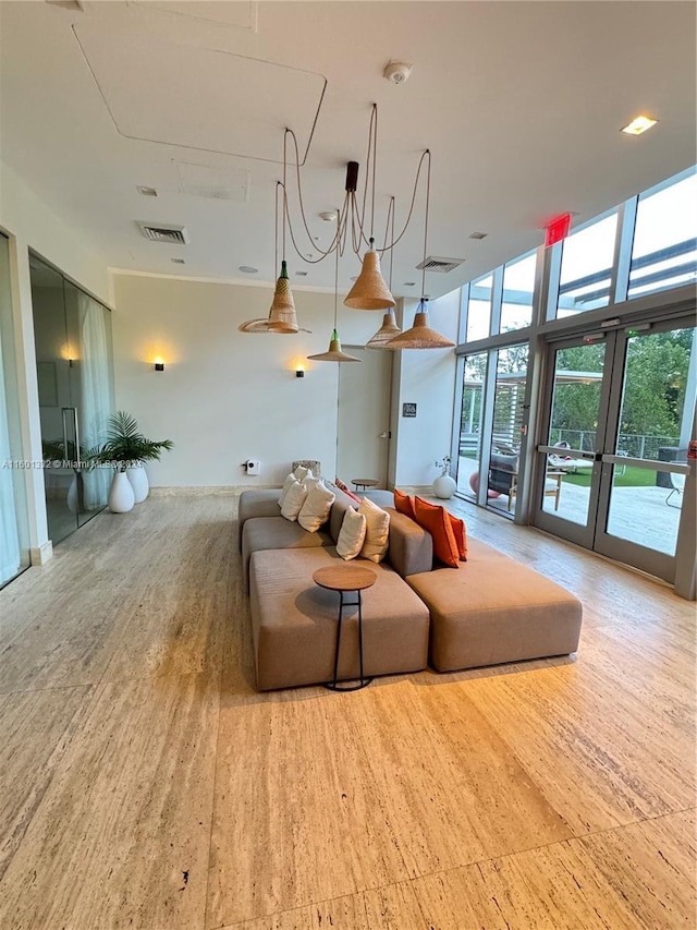 living room featuring french doors and floor to ceiling windows