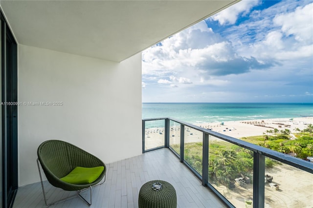 balcony with a water view and a beach view