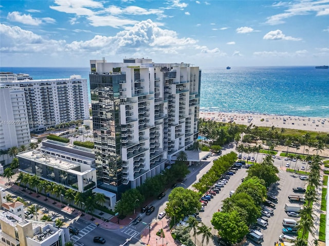 aerial view featuring a water view and a beach view