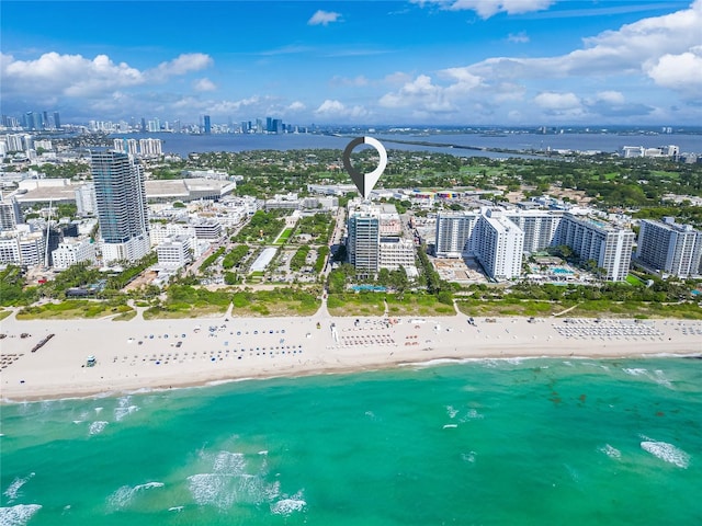 drone / aerial view featuring a water view and a beach view