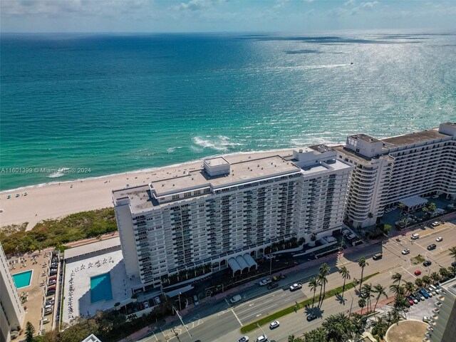 birds eye view of property with a water view and a view of the beach