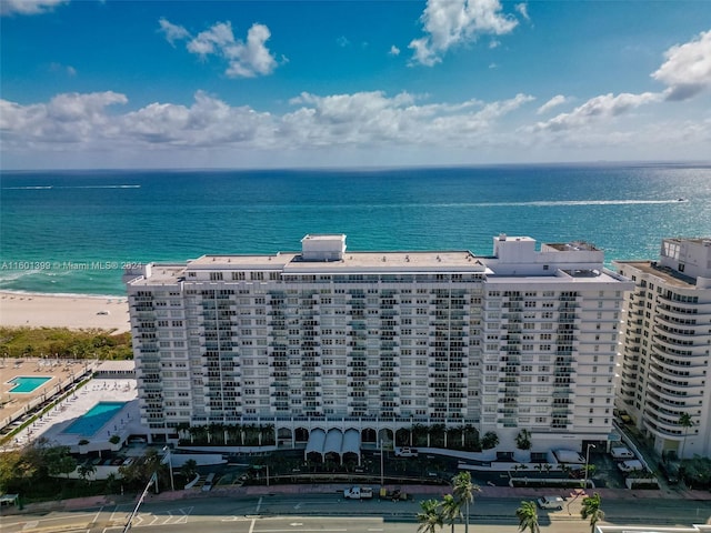 drone / aerial view featuring a view of the beach and a water view