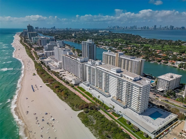 bird's eye view featuring a water view and a beach view