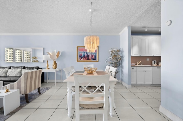 tiled dining room featuring ornamental molding, a textured ceiling, a notable chandelier, and sink