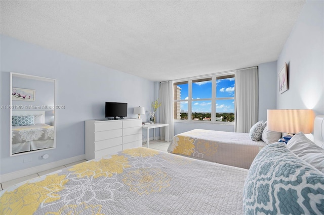 tiled bedroom with a textured ceiling