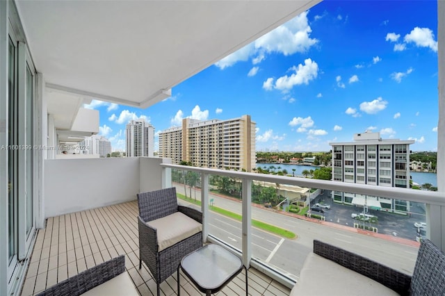 balcony featuring a water view and a view of city
