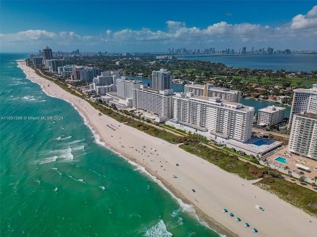 birds eye view of property featuring a beach view, a water view, and a view of city