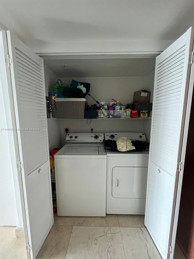 clothes washing area with separate washer and dryer