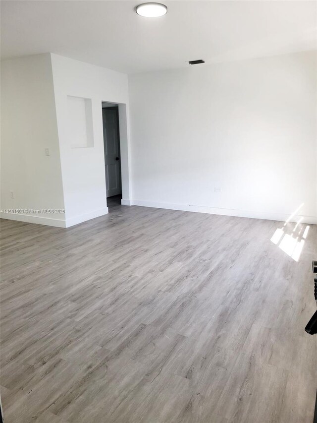 unfurnished room with hardwood / wood-style floors