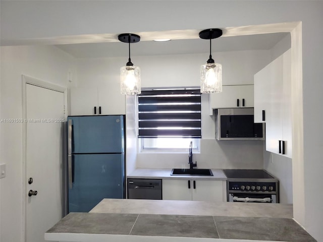 kitchen featuring white cabinets, pendant lighting, sink, and appliances with stainless steel finishes