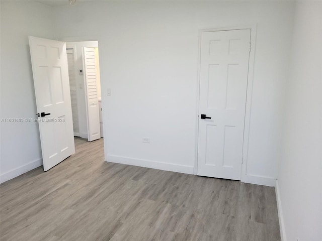 unfurnished bedroom with light wood-type flooring