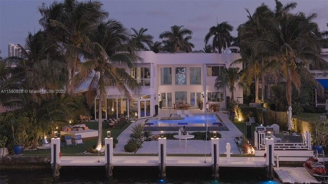 back of property with a patio area and pool water feature