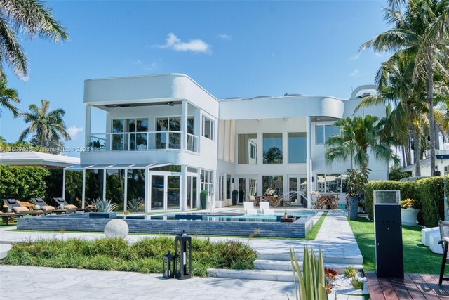 view of pool featuring pool water feature, a yard, and a water view