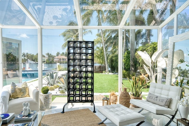 sunroom / solarium featuring a water view